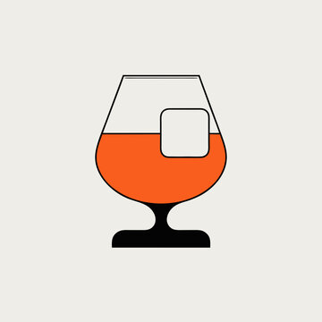 Brandy glass with ice cube, isolated on a light background