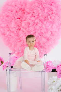 Small Toddler Girl Sitting in Transparent Chair