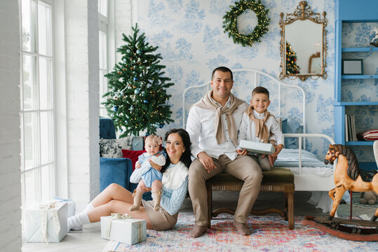 Happy Family With Children Posing In Festive Christmas Interior