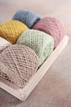Skeins of yarn. Yarn of medium thickness for knitting. Yarn for knitting or crocheting. Multicolored skeins of cotton yarn. Hobby concept