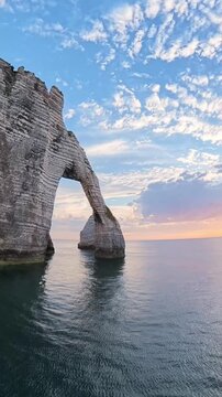 Etretat france sunrise over alabaster coast natural arches and cliffs