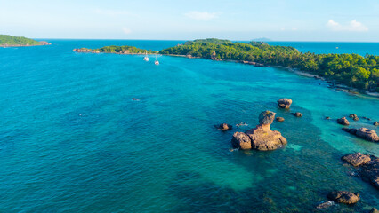Obraz premium Aerial view of beautiful landscape, tourism boats, and people swimming on the sea and beach on Gam Ghi island in Phu Quoc, Kien Giang province, Vietnam