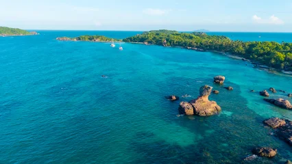 Fototapeten Tropischer Strand Aerial view of beautiful landscape, tourism boats, and people swimming on the sea and beach on Gam Ghi island in Phu Quoc, Kien Giang province, Vietnam  © CravenA