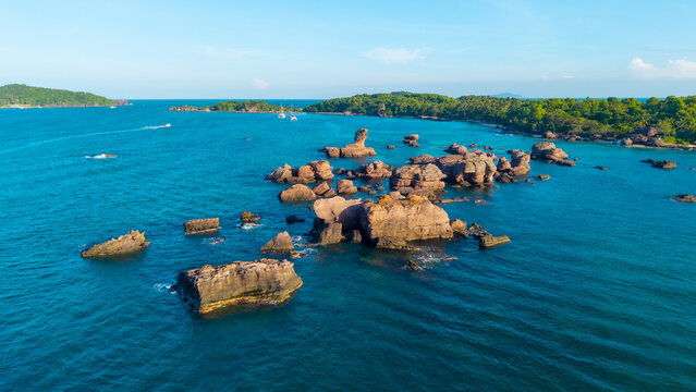 Aerial view of beautiful landscape, tourism boats, and people swimming on the sea and beach on Gam Ghi island in Phu Quoc, Kien Giang province, Vietnam