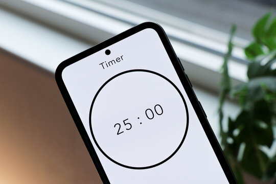 Phone with a black and white 25-minute timer to study with the pomodoro method on a blurry background