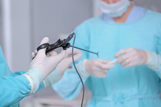 Modern laparoscopic surgery. Surgical intervention through small openings. Team of surgeons. Laparoscopic instruments