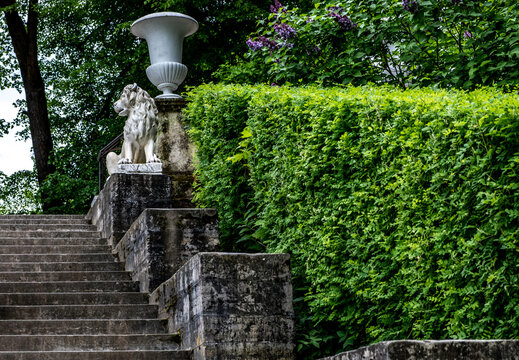 Stone staircase with a lion on the parapet in the park.