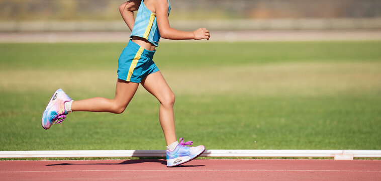 Child running in stadium. Kids run on outdoor track. Young athlete training. Jogging for kid, training and children sport healthy lifestyle concept