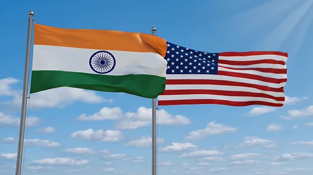 India and USA Flags Waving - This video features the national flags of India and the United States of America waving together against a clear blue sky with scattered clouds.