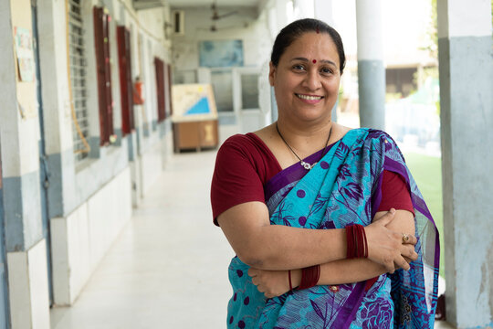 Portrait of dedicated female NGO workers arm crossed looking at the camera with confidence, highlighting women's leadership, social service, community support, education, and empowerment in India.