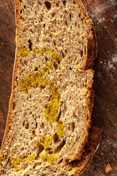 Slice of fresh artisan sourdough bread with olive oil. Close-up view