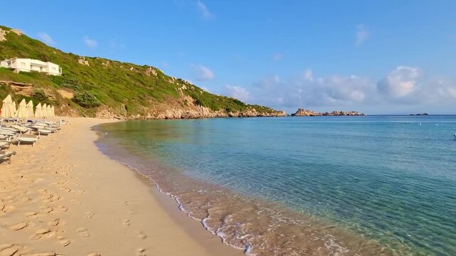 Beautiful calm sea and golden sand on Rena Bianca beach, in sunny summer morning, Santa Teresa di Gallura, Sardinia, Italy
