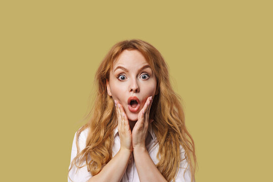 Close-up portrait of nice, redhead attractive girl opened mouth. The woman is surprised.
