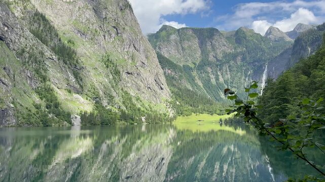 Panoramic, scenic view of Obersee Lake. Mountains and Rothbach waterfall in the background. Chrystal clear water. Obersee, Bavaria, Germany