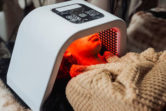 Client relaxes during a professional red LED light therapy facial designed to support skin rejuvenation, collagen production, and overall complexion improvement in a medical spa.