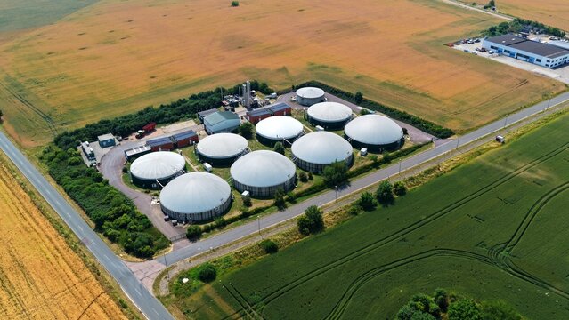 Aerial View of Biogas Plant with White Domes in Golden Fields