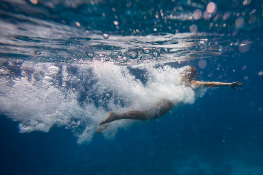 diver girl in action swimming in water 