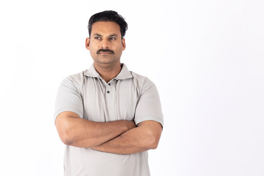 Portrait of indian young happy man arm crossed 
on white background