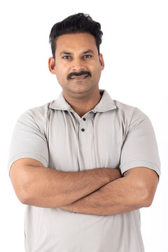 Portrait of indian young happy man arm crossed 
on white background