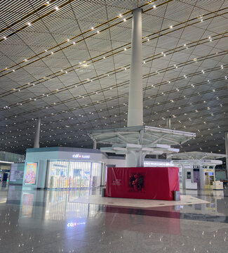 Modern duty free shops beneath vast patterned terminal roof at Beijing Airport China