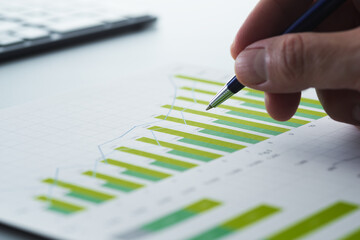Business report and financial data analysis. Performance analytics with statistical graphs and charts. Businessman reviewing plan and making strategy on desk. © tadamichi