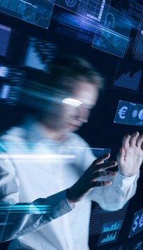 Businessman interacting with floating holographic financial charts and currency symbols in a futuristic digital environment, representing digital finance and advanced data analysis.