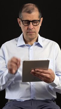 Tablet, filming and man on set with lights reading for documentary interview or podcast episode.