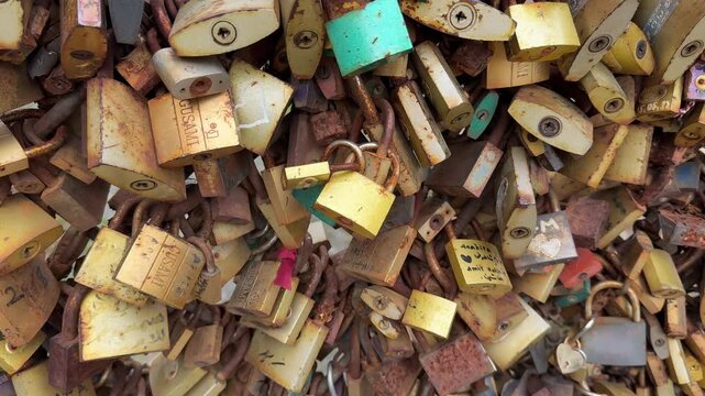 Padlocks love locks romance, many colorful metal locks attached to a bridge fence symbolizing eternal commitment and affection between couples in love