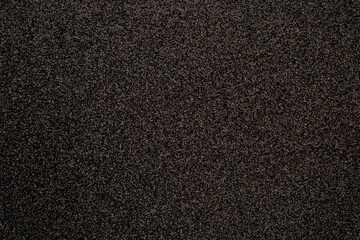 Fototapeta premium Close up of a dark textured surface with subtle glitter for background usage