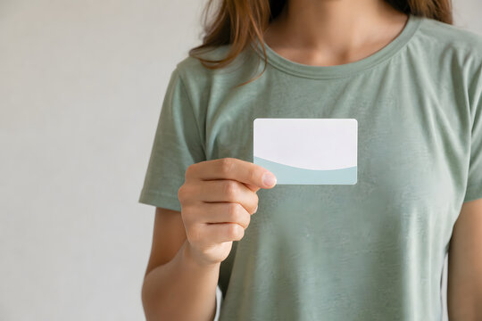 Woman holding blank health information card in soft light