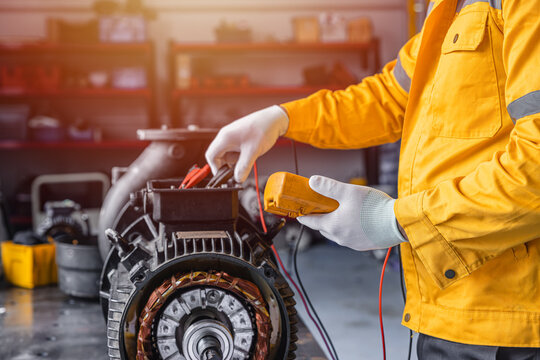 Engineer Checking DC Motor, Technician Man in Garage check inspecting service maintenance Stator.