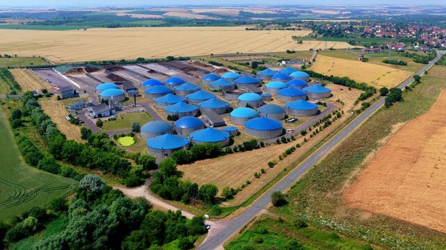 Aerial Overview of Large Blue Dome Biogas Plant in Agricultural Landscape