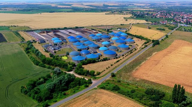 Aerial Drone Video of Large Blue Dome Biogas Plant in Rural Landscape