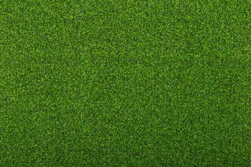 Artificial soccer turf texture with dense green synthetic grass blades in close up view. Sports background for soccer field, training ground, playground, and outdoor design. © natrot