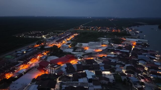 Aerial night view of Kuala Gula fishing village from drone