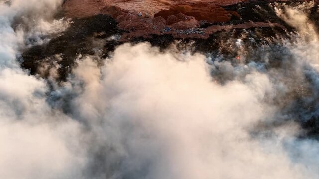 Aerial drone view of fire burning at landfill site