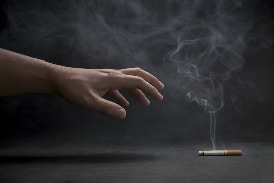 Hand Reaching Toward Cigarette Through Swirling Smoke