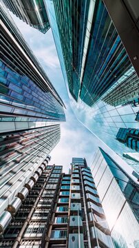 Low angle time lapse view the skyscrapers in the City of London, England, with moving clouds as concept for modern architecture and urbanism