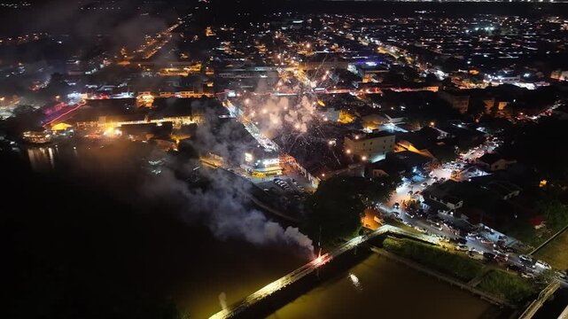 Drone aerial fireworks over Nibong Tebal town riverfront