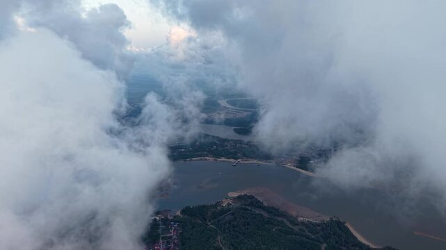 Thick clouds swirl above the river