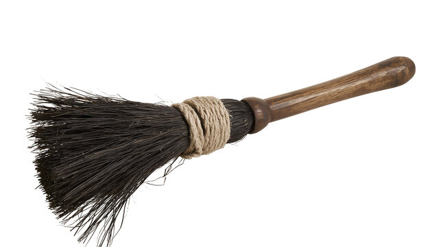 Rustic wooden broom with coarse bristles and twine binding
