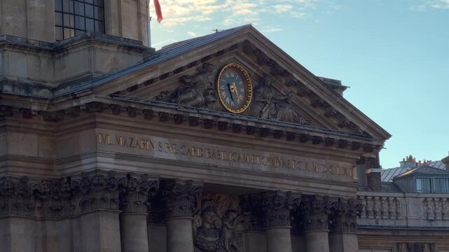 View of the grand classical pediment and structural columns of the main pavilion at the Institut de France in Paris, France