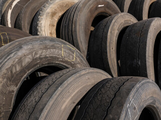 Stack of old car tires in recycling facility © enginakyurt