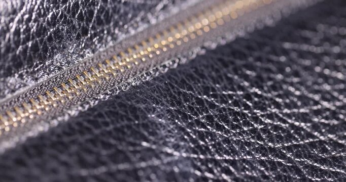 details of a natural black leather bag after prolonged use, details and pieces of natural leather used for the production of items, wrinkle