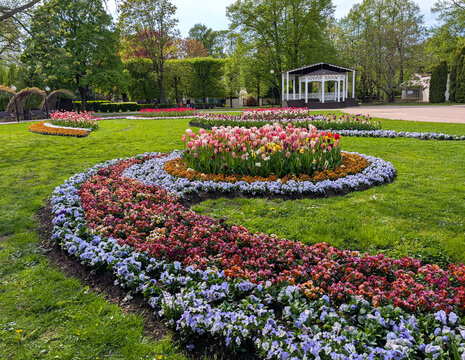 Aesthetic public square landscape design with beautiful flowerbeds and gazebo in Jurmala Latvia