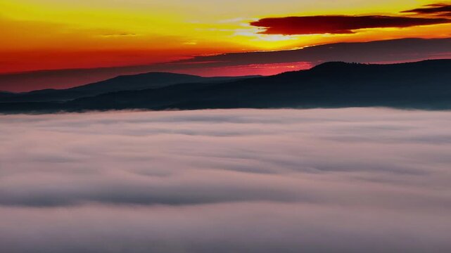 Sunrise over mountain range with sea of clouds
