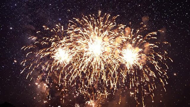 Vibrant golden fireworks exploding against a starry night sky background, for celebration and, new year events