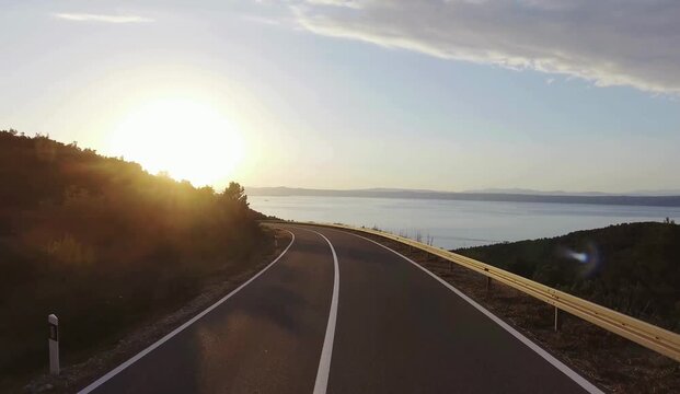 Sunset and sunrise journey across city roads, rural highways and river landscapes, empty asphalt route with car driving under dramatic sky, clouds and horizon