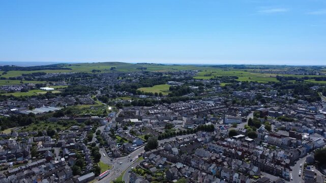 High aerial view of the town of Ulverston in Cumbria showing the streets and main road surrounded by landscape