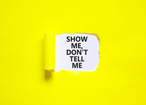 Tell or show symbol. Concept words Show me, do not tell me on beautiful white paper. Beautiful yellow paper background. Business tell or show concept. Copy space.